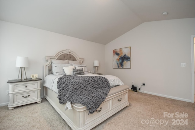 carpeted bedroom with lofted ceiling