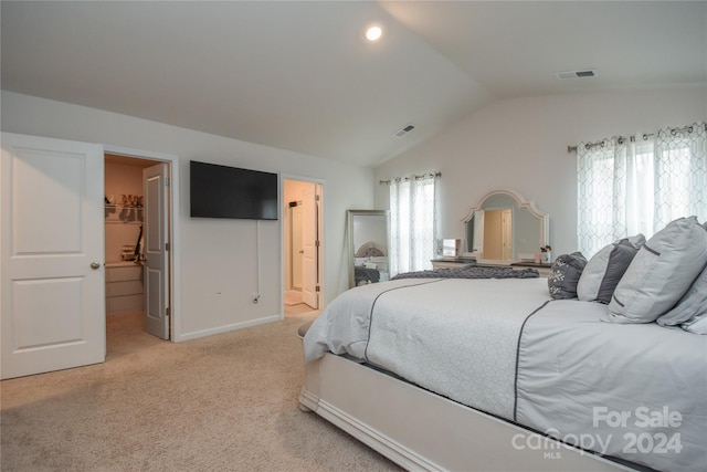 carpeted bedroom featuring a closet, a spacious closet, multiple windows, and lofted ceiling