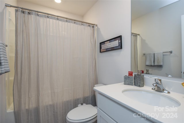 full bathroom with vanity, toilet, and shower / tub combo with curtain