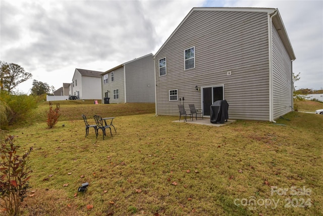 back of house featuring a patio area and a yard