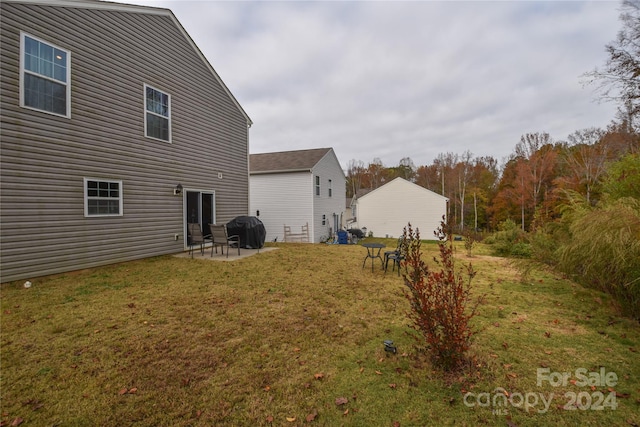 rear view of house featuring a patio area and a yard