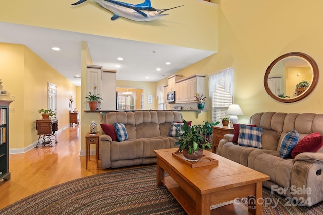 living room with plenty of natural light and light hardwood / wood-style flooring