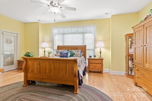 bedroom with light hardwood / wood-style floors and ceiling fan