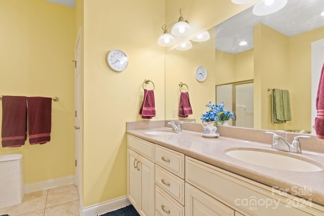 bathroom with walk in shower, tile patterned flooring, and vanity