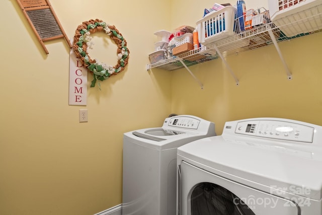 clothes washing area with washer and clothes dryer