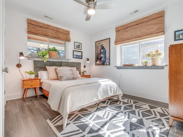 bedroom with hardwood / wood-style floors and ceiling fan