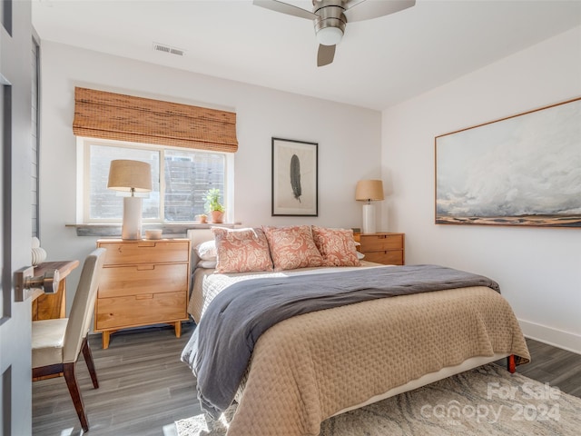 bedroom with dark hardwood / wood-style flooring and ceiling fan