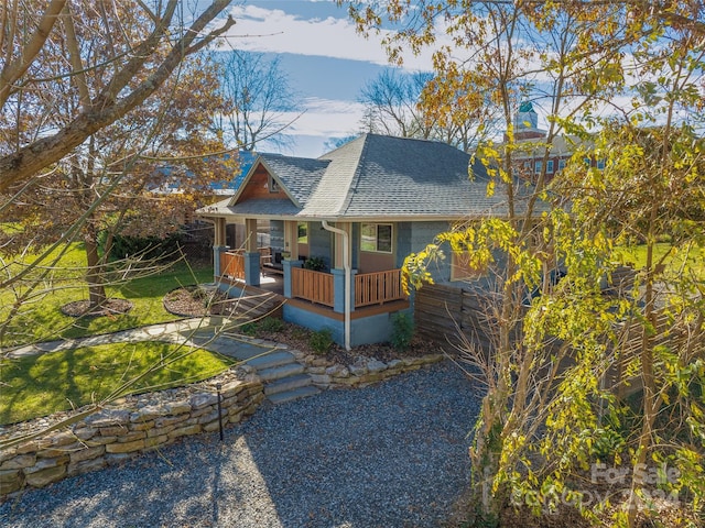 view of front of house with a porch and a front yard