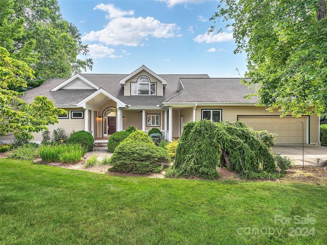 view of front of house featuring a garage and a front yard