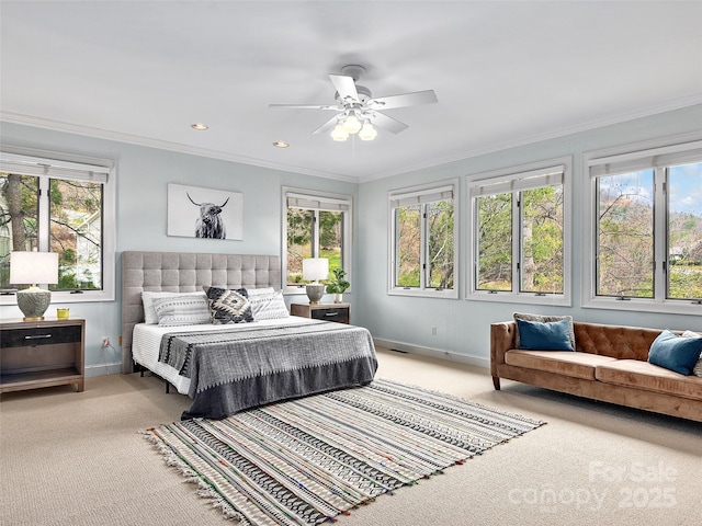 bedroom featuring ornamental molding, carpet, and multiple windows