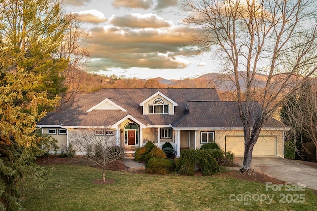 cape cod-style house with a front yard, driveway, and an attached garage