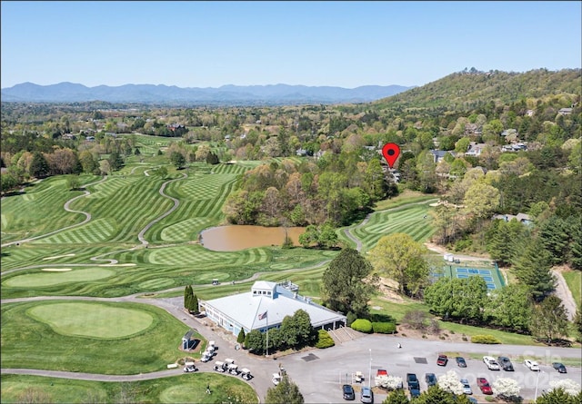 drone / aerial view featuring view of golf course and a mountain view