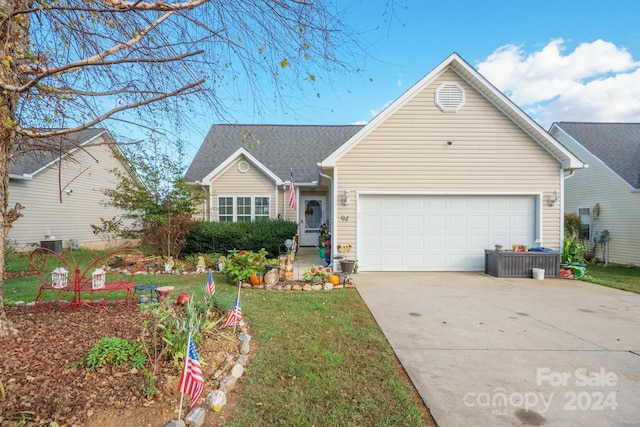 ranch-style house featuring a front lawn and a garage