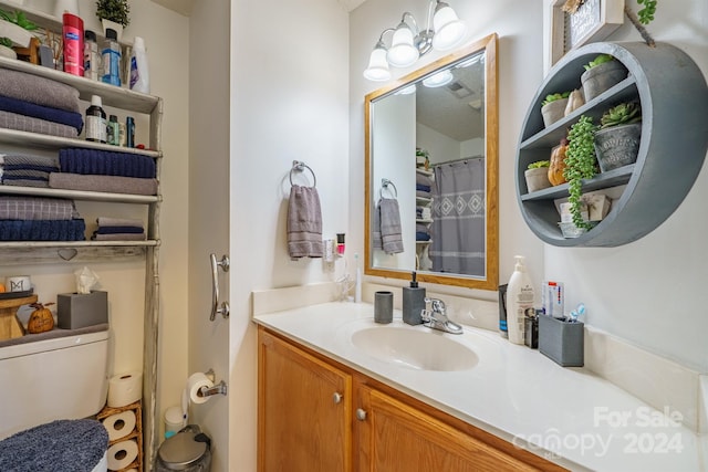 bathroom featuring vanity, a notable chandelier, and toilet