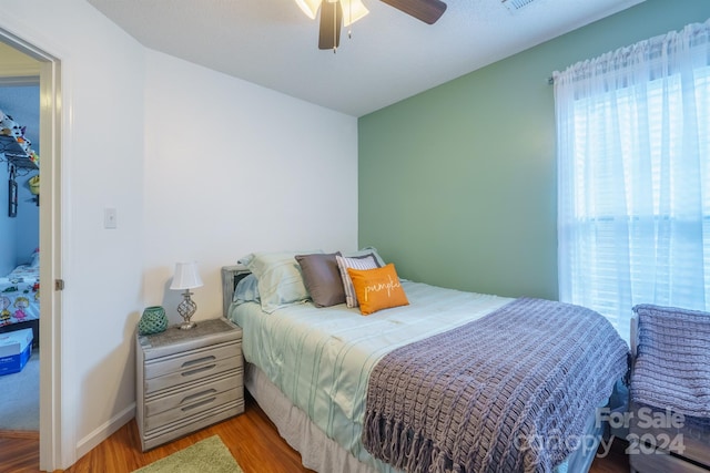 bedroom with ceiling fan and light hardwood / wood-style flooring