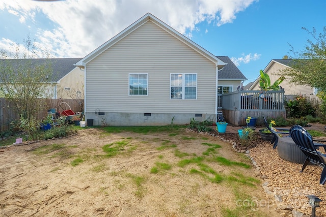 rear view of property featuring a deck