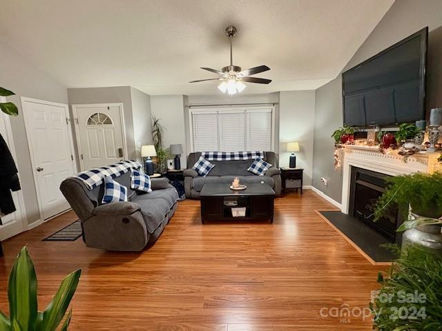 living room with ceiling fan and light wood-type flooring