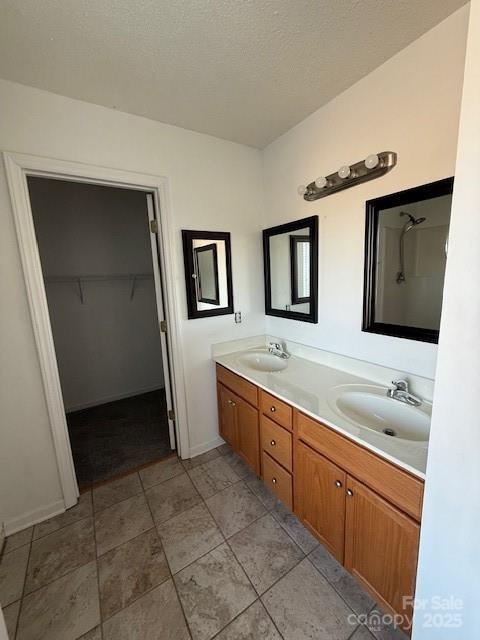 bathroom with vanity and a textured ceiling