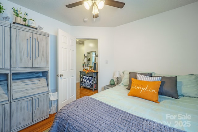 bedroom with wood-type flooring and ceiling fan