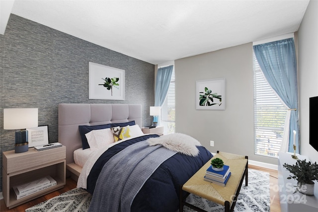 bedroom with hardwood / wood-style flooring and multiple windows