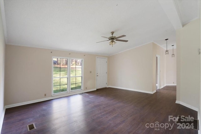 spare room featuring dark hardwood / wood-style floors, ceiling fan, and crown molding