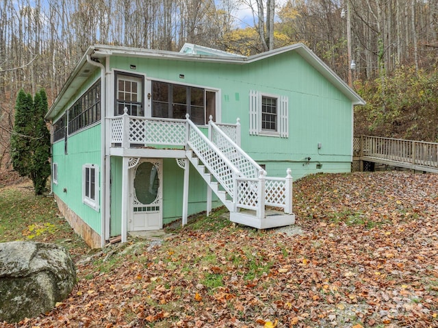 rear view of house featuring a sunroom