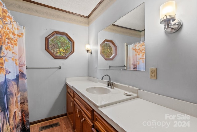 bathroom with vanity, a textured ceiling, and hardwood / wood-style flooring