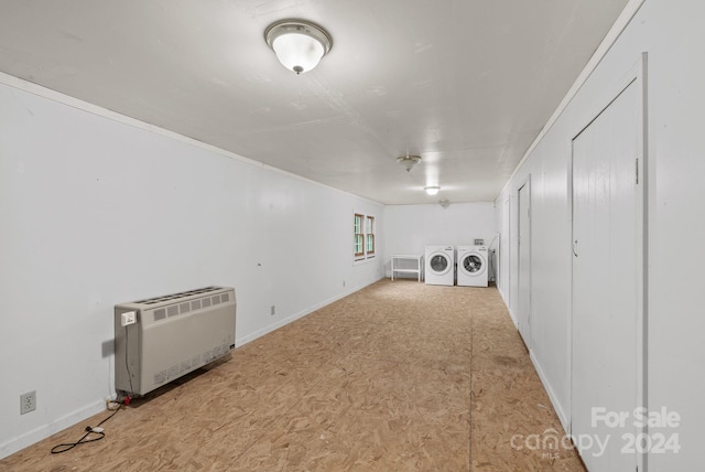 basement featuring washer and dryer and heating unit