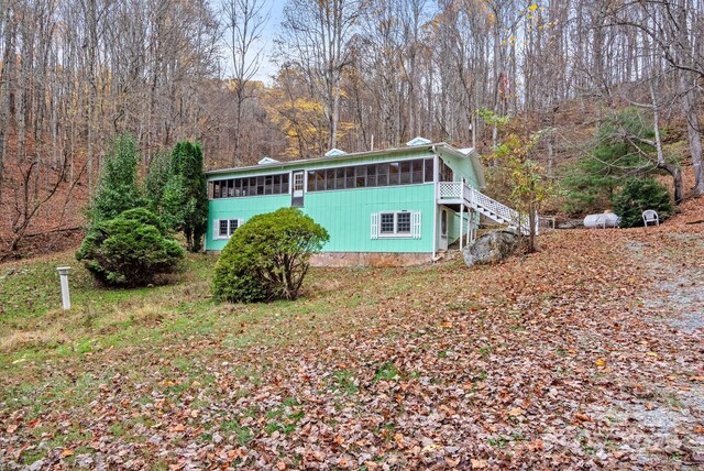 61 Doe Loop, Hot Springs, NC 28743 - view of side of property featuring a sunroom, stairway, and a forest view