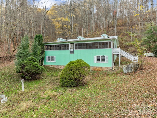 61 Doe Loop, Hot Springs, NC 28743 - view of home's exterior featuring a sunroom, stairway, and a wooded view