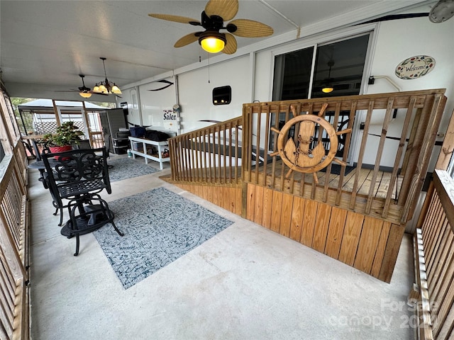 sunroom / solarium featuring ceiling fan