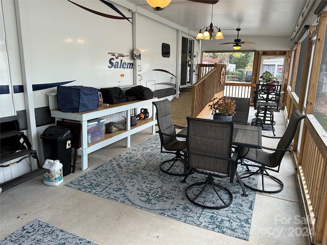 sunroom with ceiling fan with notable chandelier