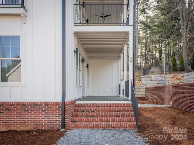 view of exterior entry featuring a balcony