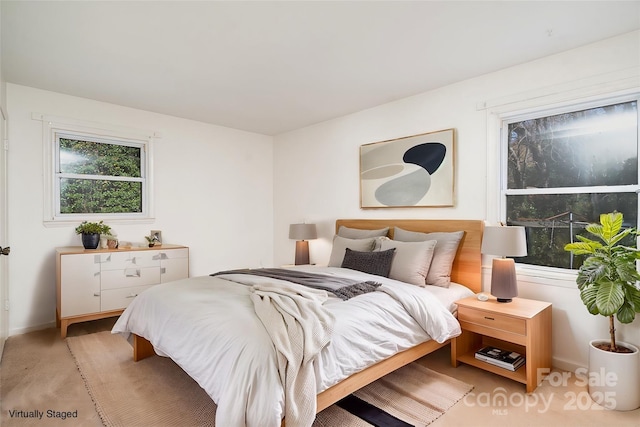 bedroom with light colored carpet