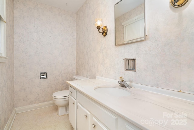 bathroom with tile patterned flooring, vanity, and toilet