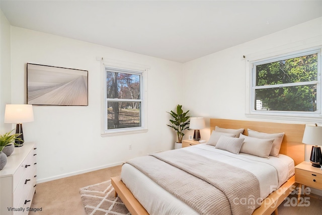 carpeted bedroom featuring multiple windows