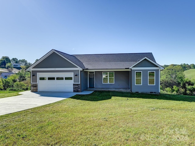 view of front of property with a garage and a front lawn