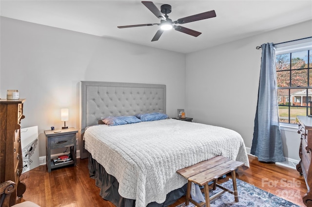 bedroom featuring ceiling fan and dark hardwood / wood-style flooring