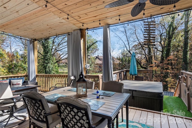 sunroom with ceiling fan and wood ceiling