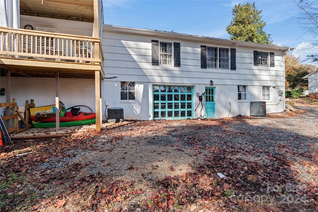 back of house featuring central AC and a balcony