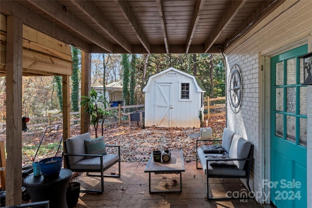 view of patio with outdoor lounge area and a storage shed