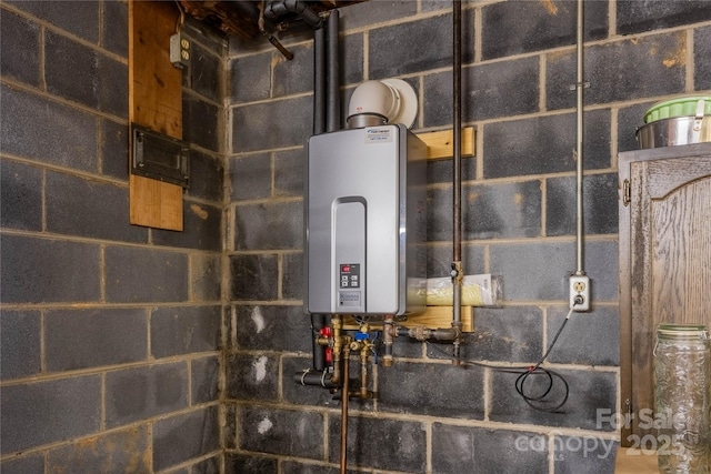 utility room featuring water heater