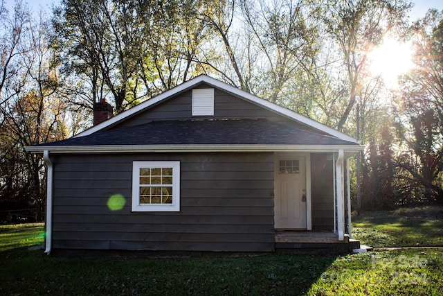 view of side of home featuring a lawn