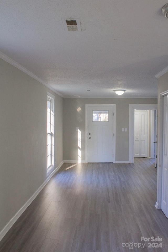 interior space with wood-type flooring and ornamental molding