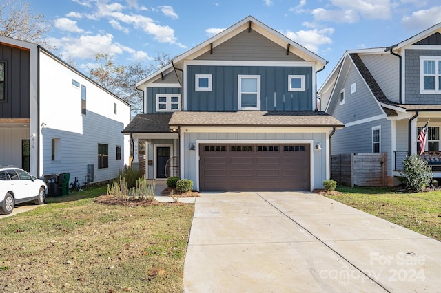 view of front of house featuring a garage and a front lawn