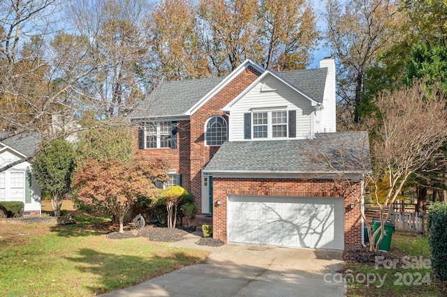 front facade with a garage and a front yard