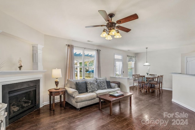 living room featuring dark hardwood / wood-style floors and ceiling fan