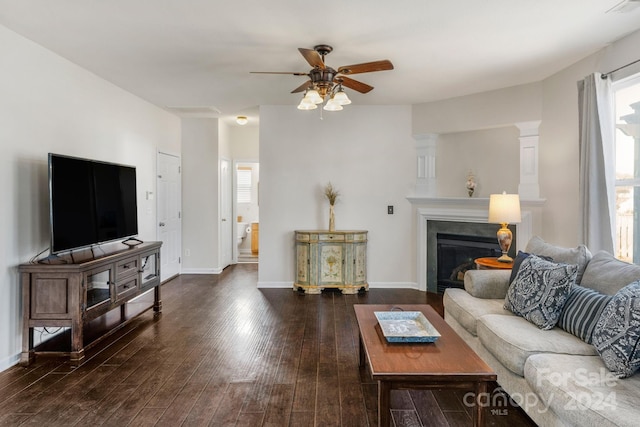 living room featuring dark hardwood / wood-style floors and ceiling fan