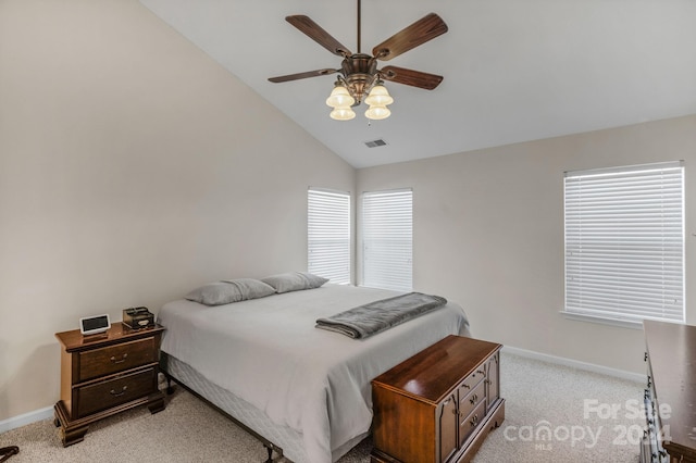 carpeted bedroom with ceiling fan and lofted ceiling