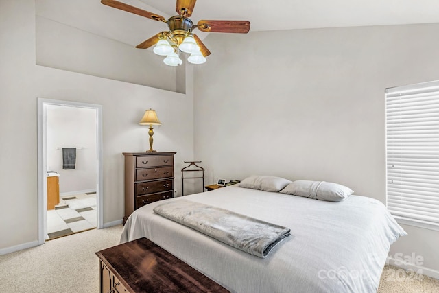 bedroom featuring light carpet, ensuite bath, ceiling fan, and lofted ceiling